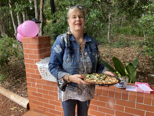 Sandy Hardy arrives bearing a tray of delicious vegetarian pizza.  